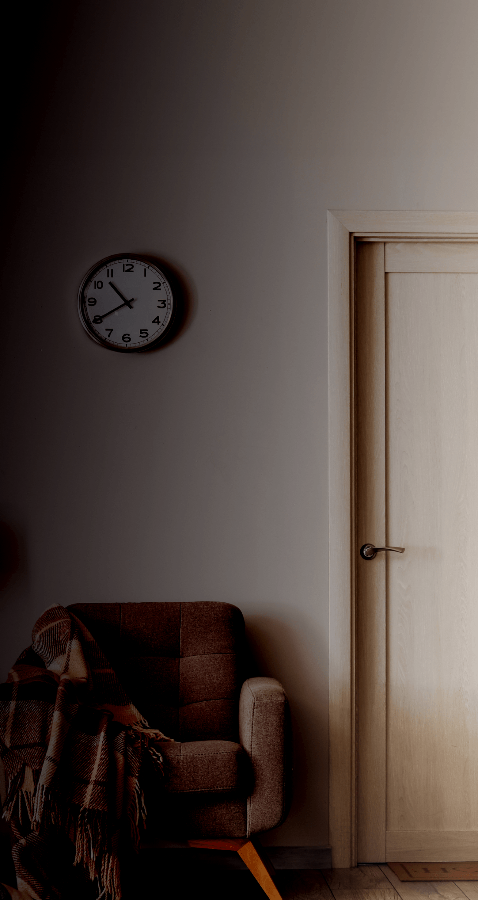 lamp and chair beside white door